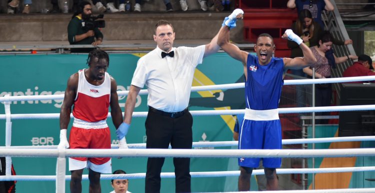 Guyana’s Joel Williamson, left, lost by a unanimous decision yesterday to Miguel De La Cruz of the Dominican Republic in his 63.5kg round of 16 bout at the Pan Am Games in Santiago, Chile