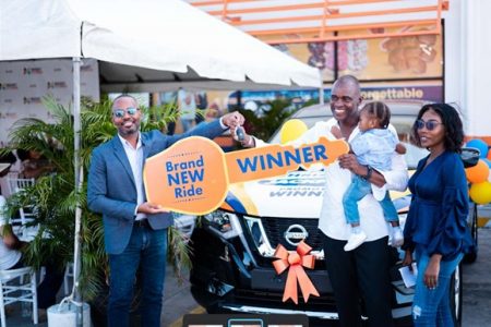 In picture from L-R, Christpen Bobb-Semple, Assistant Vice President of Massy Stores Guyana presents the keys to a new 2022 Nissan X-Trail to Colin Weekes, winner of the 2022 Christmas Jackpot Promotion.