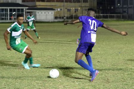 Shamar Beckles (right) of Anns Grove is trying to evade the pursuit of Stephon Jupiter of Den Amstel in their KFC League Cup encounter.