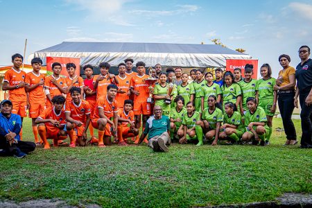 The boys champion and girls third-place finishers, Bartica Secondary, display some of their prizes at the official presentation ceremony.
