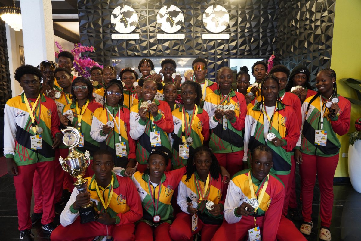Team Guyana’s many medalists pose with the Athletics Championship trophy (photo courtesy of Calvin Chapman).