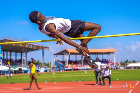 Romarion Wolfe sails over the bar in the high jump in the Boys’ U-14 division to register a new record of 1.66m, beating the previous record of 1.63 m (Photo compliments of the Ministry of Education)
