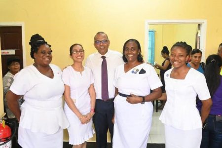 Minister of Health, Dr Frank Anthony (centre) with health care workers (DPI photo)