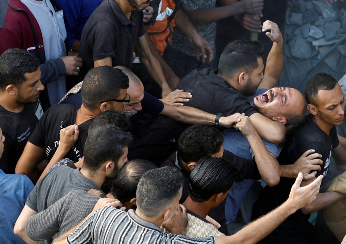 A Palestinian man reacts, as people search for casualties, at the site of Israeli strikes on houses, amid the ongoing conflict between Israel and Palestinian Islamist group Hamas, at the Magazi Refugee Camp, in central Gaza Strip, November 5, 2023. REUTERS/Mohammed Salem