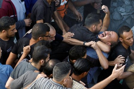 A Palestinian man reacts, as people search for casualties, at the site of Israeli strikes on houses, amid the ongoing conflict between Israel and Palestinian Islamist group Hamas, at the Magazi Refugee Camp, in central Gaza Strip, November 5, 2023. REUTERS/Mohammed Salem