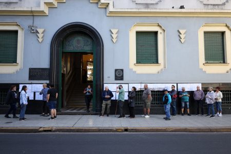 People stand outside a polling station during Argentina's runoff presidential election, in Buenos Aires, Argentina November 19, 2023. REUTERS/Cristina Sille