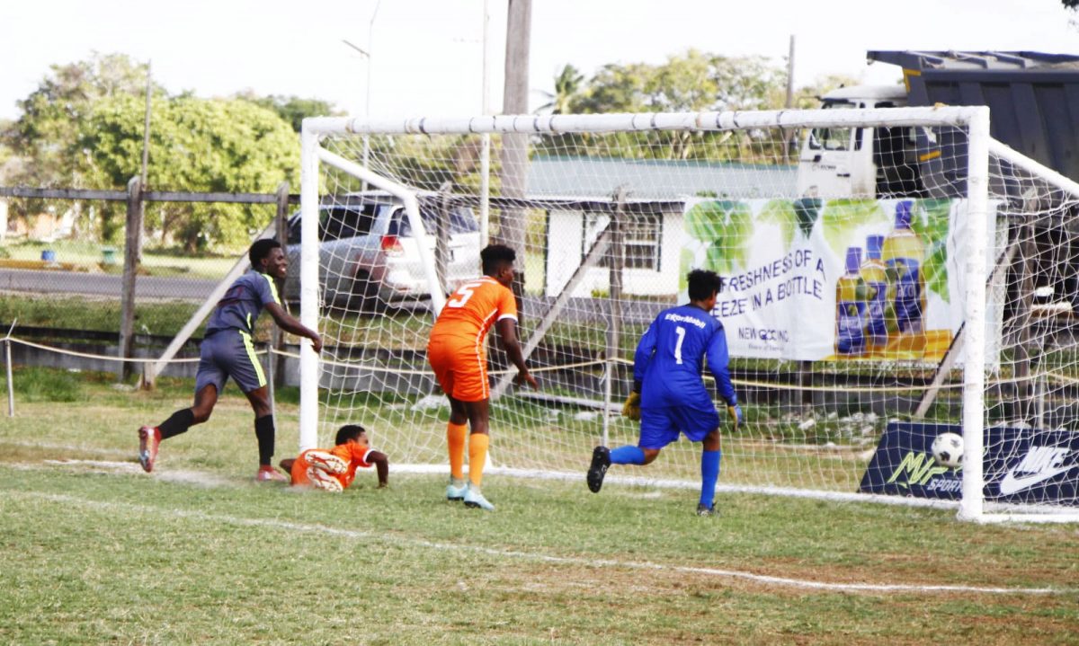 Ian Daniels (left) of Carmel is racing off to celebrate after scoring against Bartica in the Limacol Secondary Schools Football League.
