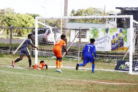 Ian Daniels (left) of Carmel is racing off to celebrate after scoring against Bartica in the Limacol Secondary Schools Football League.
