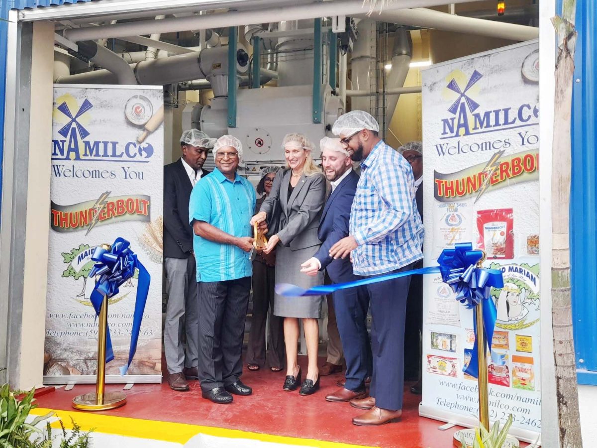 The ribbon cutting ceremony at the opening of the new NAMILCO plant. From right are President Irfaan Ali; President and CEO of Seaboard, Jack Bresky; US Ambassador to Guyana, Nicole Theriot; and Managing Director of NAMILCO, Roopnarine Sukhai 