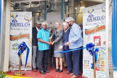 The ribbon cutting ceremony at the opening of the new NAMILCO plant. From right are President Irfaan Ali; President and CEO of Seaboard, Jack Bresky; US Ambassador to Guyana, Nicole Theriot; and Managing Director of NAMILCO, Roopnarine Sukhai 