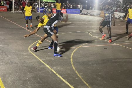 Deon Charter (yellow) of Goal is Money tussling with Romain Adams of Haynes Ballers during their quarterfinal encounter in the New Era Futsal Championship
