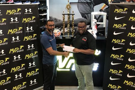 Petra Organisation Co-Director Troy Mendonca (right) receiving the sponsorship cheque from Ian Ramdeo, CEO of MVP Sports, for the Girl’s Pee Wee Football Championship
