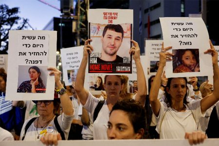 Protesters hold signs demanding the liberation of hostages who are being held in the Gaza Strip after they were seized by Hamas gunmen on October 7, in Tel Aviv, Israel November 21, 2023. REUTERS/Amir Cohen