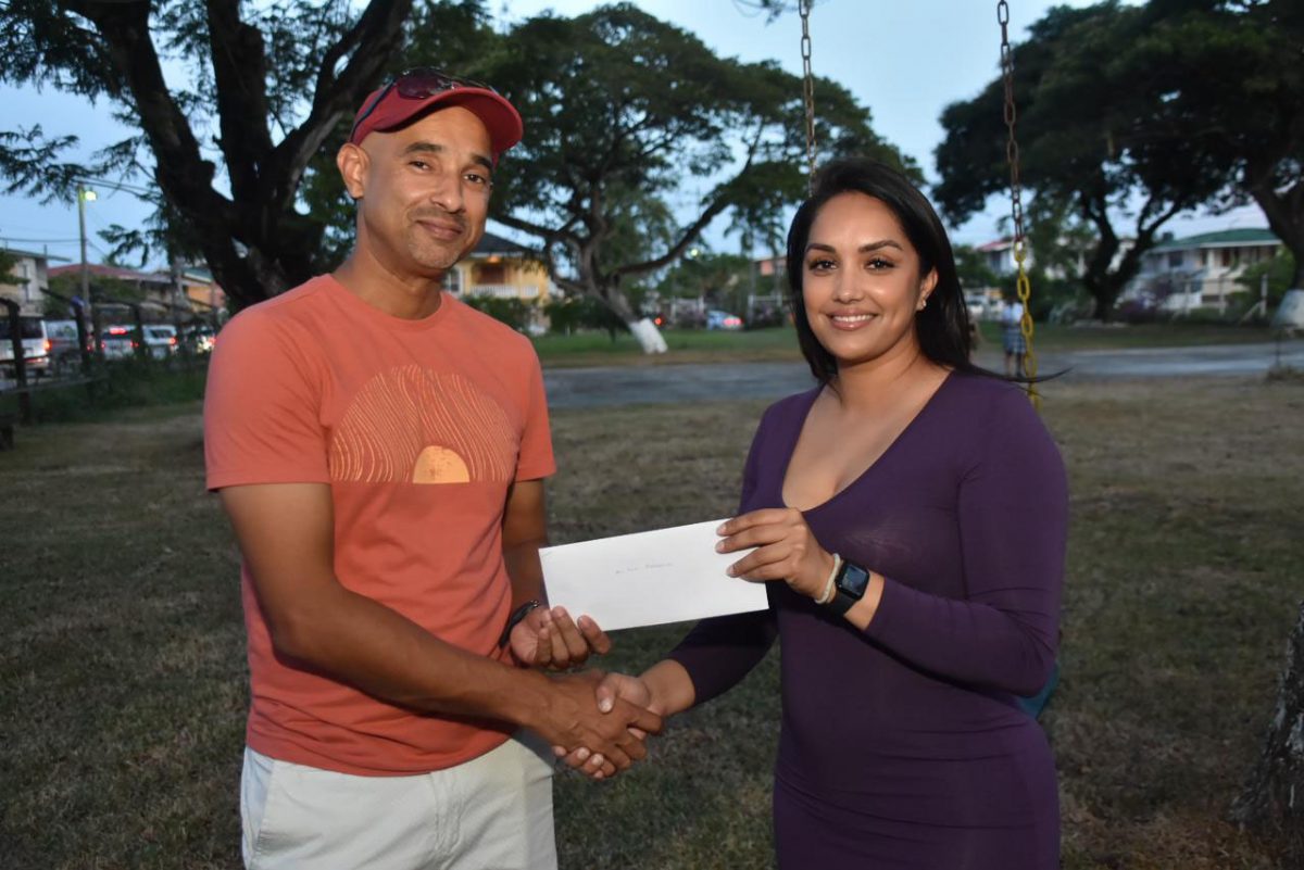 Fueled! Sadia Ali, Public Relations Officer (PRO) of Shi-Oil and 2Brothers Service Station, presents the sponsorship check to racer Ryan Rahaman