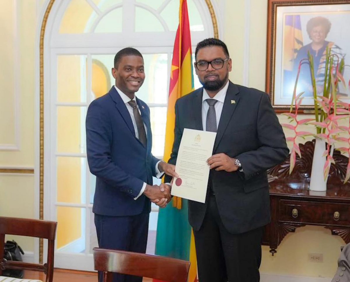 President Irfaan Ali (right) handing over the document of accession on December 6, 2022 to the Chair of the Ministerial Council of the RSS, Prime Minister of Grenada, Dickon Mitchell. (Office of the President photo)
