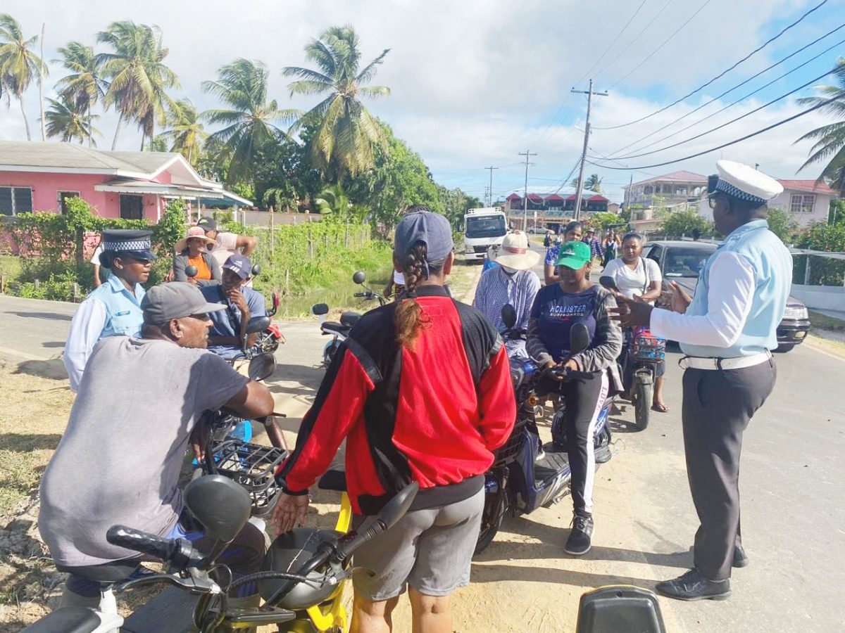  A lecture for E-bike riders was held on Thursday  in the vicinity of Cropper Primary School, Berbice by Corporal Nandlall and Woman Constable Blair during which several issues were discussed. (Guyana Police Force photo)
