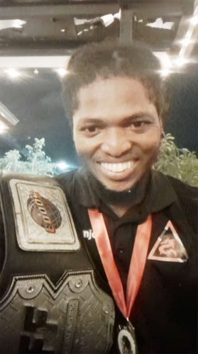 Draped in Gold! Carlos D’Anjou
poses with his spoils of war after
capturing the lightweight amateur
championship on the CUFF 18 fight card
