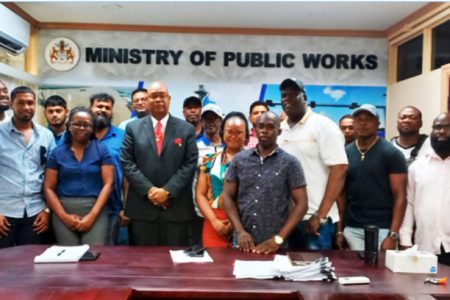 Minister Juan Edgill and the contractors 