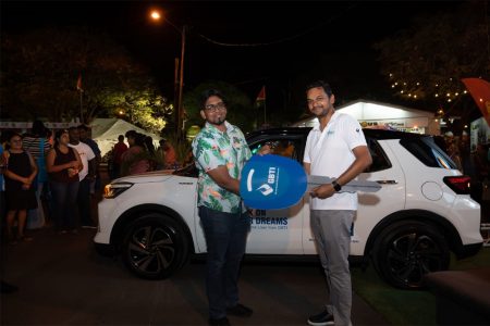 In photo, GBTI Deputy Chief Executive Officer, Shawn Gurcharran (right) presents the key to Rajendra Khelawan. (GBTI photo) 