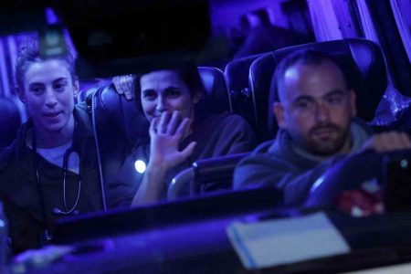 A vehicle carrying hostages released as part of a deal between Israel and Palestinian Islamist group Hamas, drives by, in Ofakim, Israel, November 30, 2023. REUTERS/Alexander Ermochenko