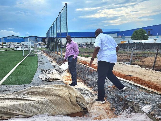 Howard McIntosh (right), Head of One CONCACAF and Caribbean Projects, assesses the work underway at the National Training Centre in Providence alongside GFF President Wayne Forde
