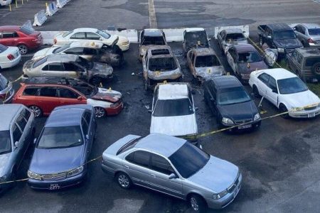An aerial view of the impounded vehicles which were destroyed in an early morning fire at the Caroni Licensing Office compound yesterday. Fourteen cars were said to have been destroyed in the blaze.