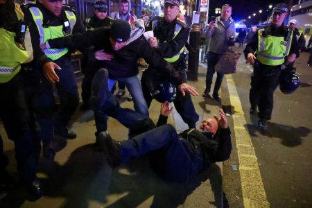 Police officers detain a counter-protester on the day of a demonstration in solidarity with Palestinians in Gaza, amid the ongoing conflict between Israel and the Palestinian Islamist group Hamas, in London, Britain, November 11, 2023. REUTERS/Hannah McKay