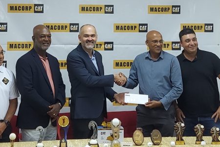 MACORP’s General Manager, German Consuegra (left), presents the sponsorship cheque from LGC President Patanjilee Persaud in the presence of other members of the company and the LGC.