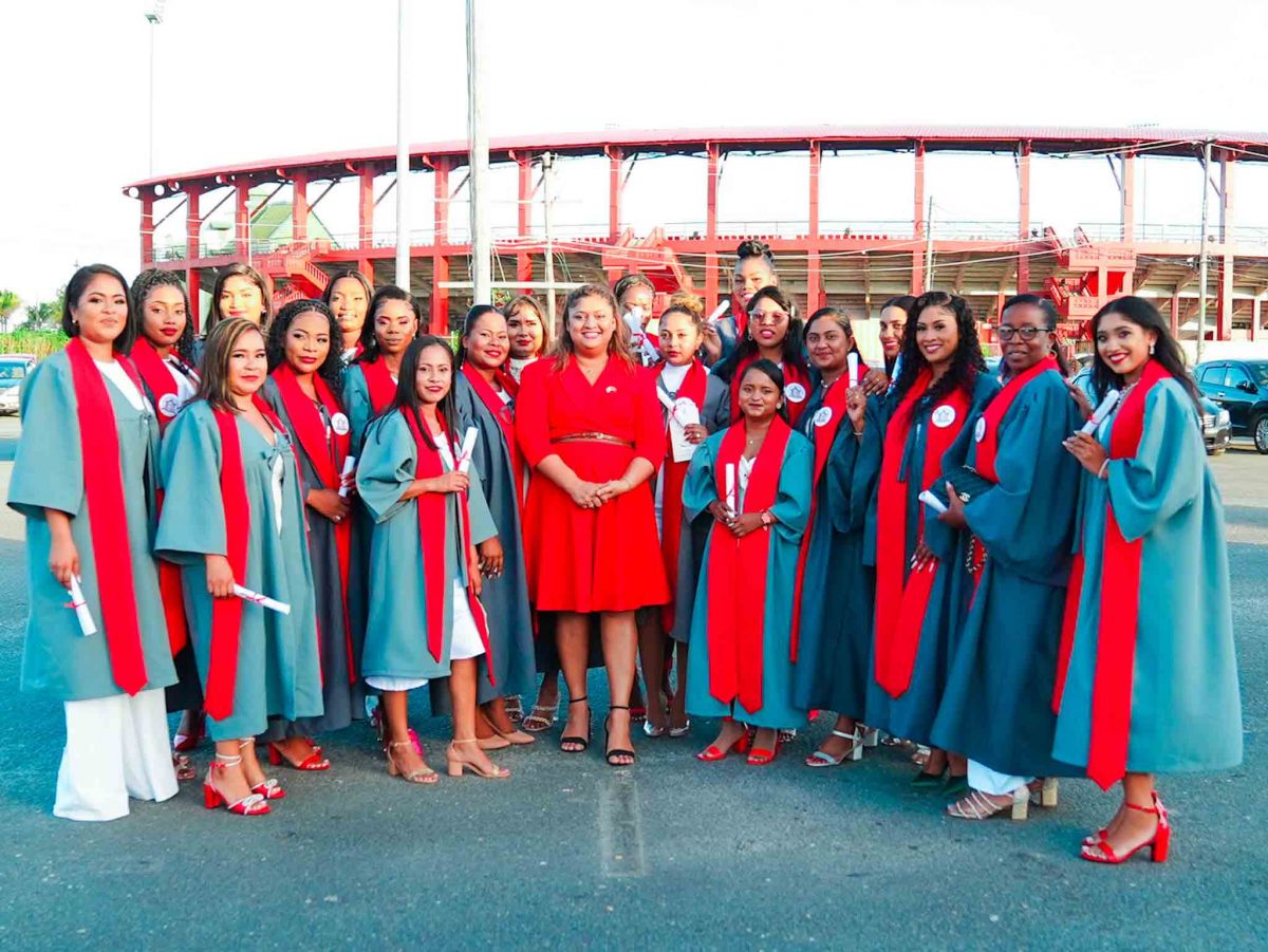 Minister of Education Priya Manickchand (centre) with some of the graduates. (Ministry of Education photo)
