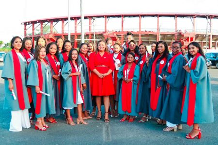 Minister of Education Priya Manickchand (centre) with some of the graduates. (Ministry of Education photo)