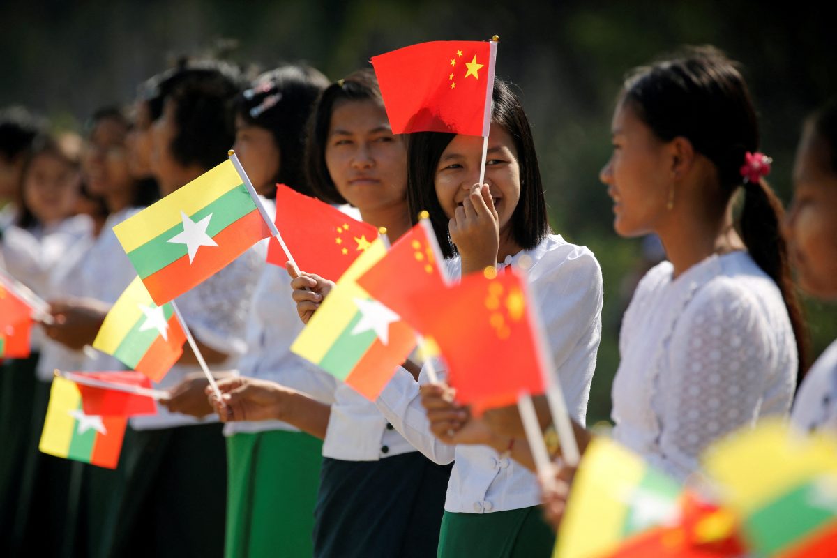 FILE PHOTO: Myanmar students hold Myanmar and Chinese flags as they prepare to welcome Chinese President Xi Jinping outside of the airport in Naypyitaw, Myanmar, January 17, 2020. REUTERS/Ann Wang/File Photo