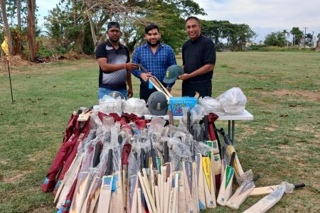 On Tuesday, over 100 cricket bats and helmets were donated by the President of the Guyana Golf Association (GGA) and Nexgen Golf Academy, Aleem Hussain (right) to Saeed Zameen, (centre), Head of the Priority Programme at Allied Arts.
