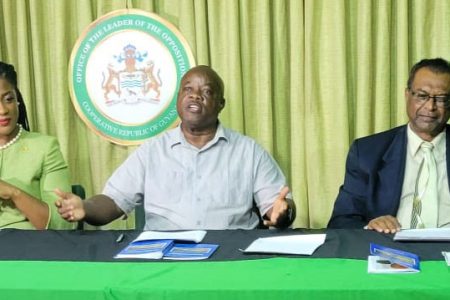 Opposition Leader Aubrey Norton (centre) speaking at the APNU+AFC press conference on Friday at right is AFC Leader Khemraj Ramjattan. At left is shadow foreign minister Amanza Walton-Desir. 