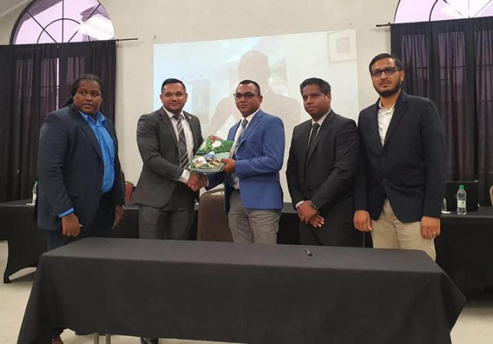 Minister of Natural Resources Vickram Bharrat (second from left) and Chateram Ramdihal (third from left) of Ramdihal and Haynes with the signed agreement for the RHVE audit. (Ministry of Natural Resources photo)