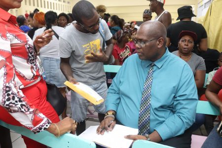 Chief Executive Officer of the Central Housing and Planning Authority Sherwyn Greaves speaking to Laing Avenue residents yesterday about the housing rehabilitation plan. (CH&PA photo)