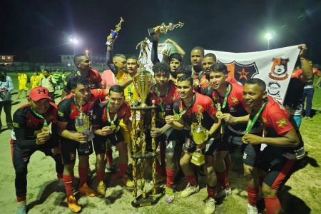 Tabatinga FC celebrate their championship trophy. 