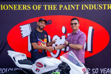 Stephen Vieira (left) receives the sponsorship package from Torginol Paints Inc., Sachin Puri.
