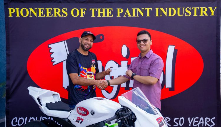 Stephen Vieira (left) receives the sponsorship package from Torginol Paints Inc., Sachin Puri.
