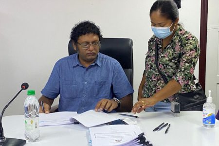 Permanent Secretary in the Ministry of Public Works, Vladim Persaud (left) with one of the contractors.