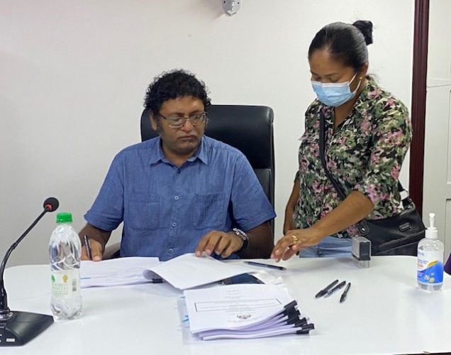 Permanent Secretary in the Ministry of Public Works, Vladim Persaud (left) with one of the contractors.