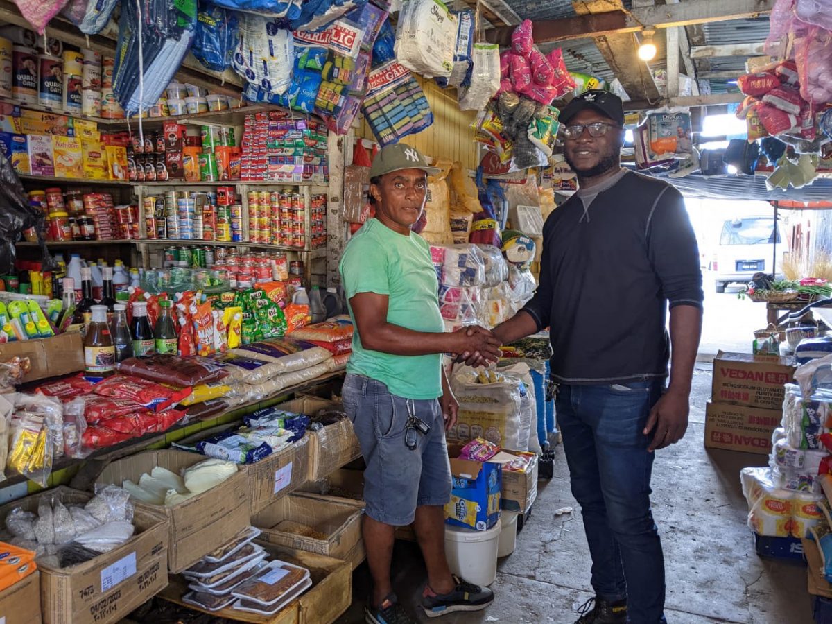 Sealed with a shake! Proprietor Adrian Kennedy (left) of Adrian Groceries has joined the list of sponsors to support the ‘East Bank versus the Rest’ street-ball championship following a brief meeting with Clayton Reece, Public Relations Officer of the tournament
