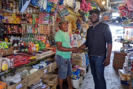 Sealed with a shake! Proprietor Adrian Kennedy (left) of Adrian Groceries has joined the list of sponsors to support the ‘East Bank versus the Rest’ street-ball championship following a brief meeting with Clayton Reece, Public Relations Officer of the tournament
