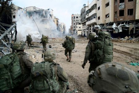 Israeli soldiers operate in the Gaza Strip amid the ongoing conflict between Israel and the Palestinian Islamist group Hamas, in this handout picture released on December 18, 2023. Israel Defense Forces/Handout via REUTERS