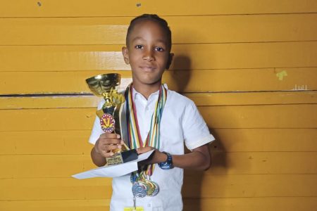 Jadon Bristol
displaying his spoils from the National Schools Cycling, Swimming, and Track and Field Championships, as well as the accolades received from the community of Nabaclis