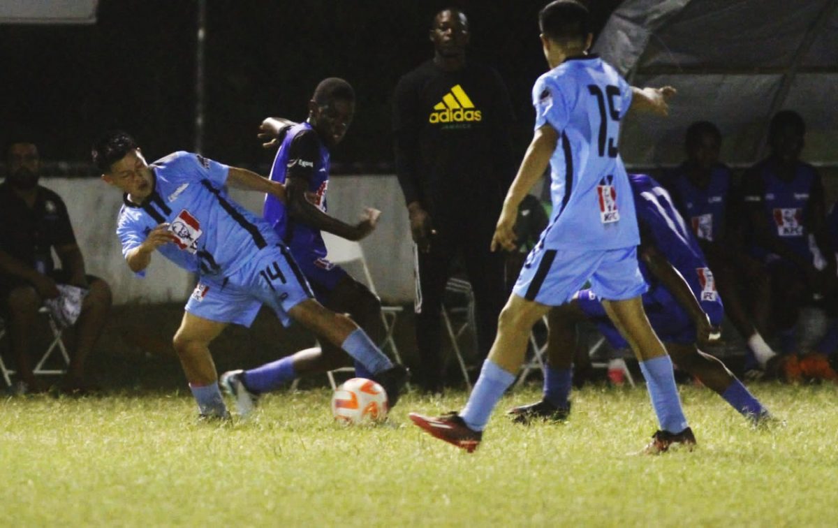 A scene from the Clarendon College and Chase Academy (light blue) encounter in the KFC Goodwill Football Championship