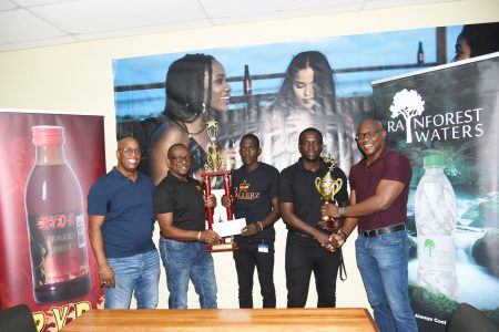 Mortimer Stewart (1st from left), Outdoor Events Manager, Oral Jones (2nd from left), Ryda Hard Wine Brand Manager, and GT Beer Brand Manager Dwain Bristol (1st from right) presenting the trophies to tournament organisers Teon Jones (centre) and Lyliton Ramsay
