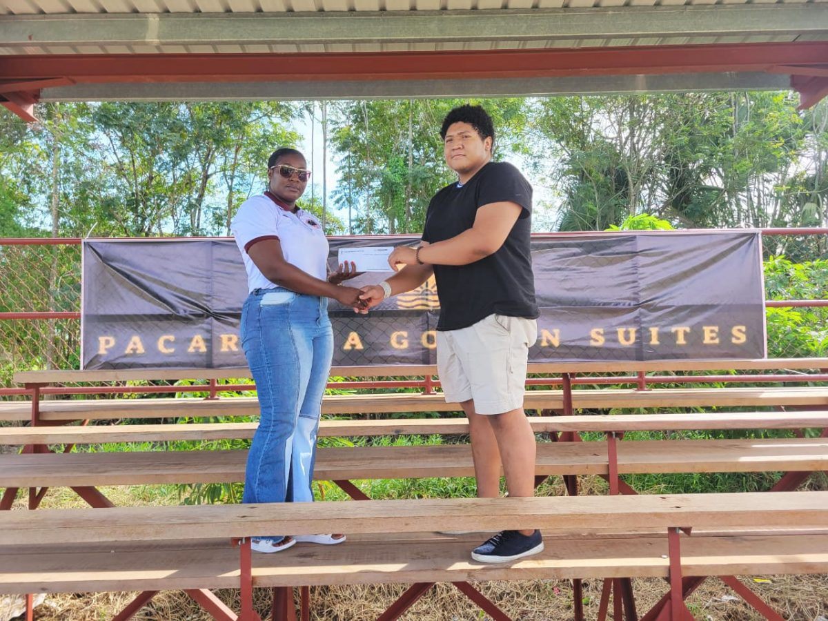 Pacaraima Golden Suite’s Amazyah Braithwaite (right) hands over the sponsorship package to Petra Organisation’s Jackie Boodie