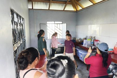 Minister of Amerindian Affairs Pauline Sukhai touring one of the completed projects with others. (Ministry of Amerindian Affairs photo)