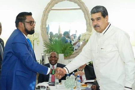 President Irfaan Ali (left) and Venezuelan President Nicolas Maduro shaking hands at one of their meetings yesterday, (Office of the President photo)