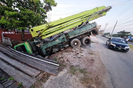  This truck went into a trench at  Vreed-en-Hoop, West Coast Demerara yesterday. The driver escaped unhurt. (Police photo)